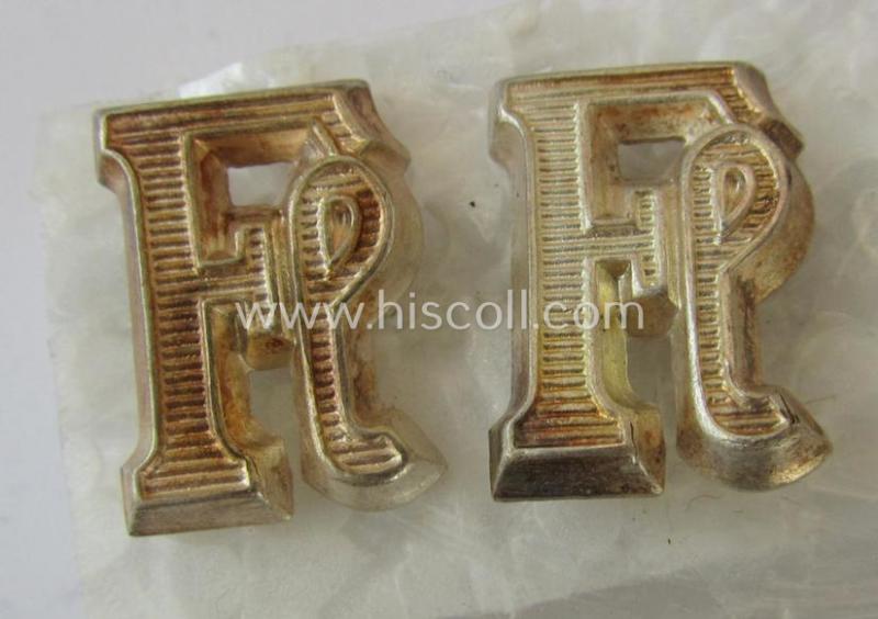 Superb - and fully matching! - pair of Waffen-SS-related-, silver-coloured (ie. 'Buntmetall'-based-) so-called: 'Fl'-shoulderstrap-'cyphers' (ie. 'Ziffern'), as was intended for an: 'SS-Unterführer der Fla.MG-Abteilungen'
