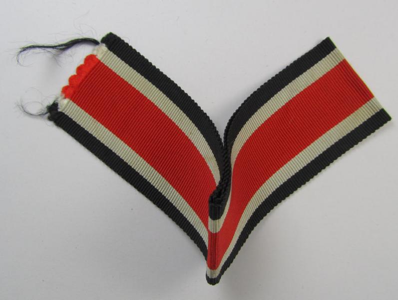Neat spare-part: a non-confectioned- (ie. full length- ie. 29 cms. long-sized-) ribbon (ie. 'Bandabschitt') as was intended for the: 'Eisernes Kreuz II. Klasse' and that comes in an overall very nice- (ie. 'virtually mint ie. unissued'-), condition