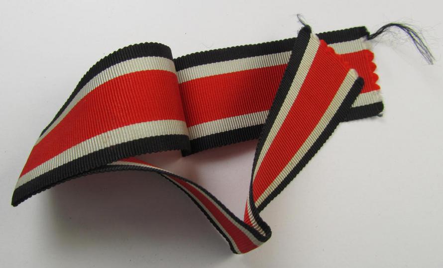 Neat spare-part: a non-confectioned- (ie. full length- ie. 29 cms. long-sized-) ribbon (ie. 'Bandabschitt') as was intended for the: 'Eisernes Kreuz II. Klasse' and that comes in an overall very nice- (ie. 'virtually mint ie. unissued'-), condition