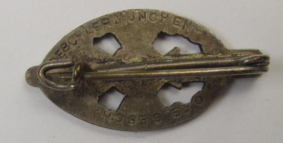 Membership-lapel-pin as was intended to signify membership within the: 'Nationalsozialistischer Kriegsopferversorsung' (ie. 'N.S.K.O.V.') being a maker- (ie. 'Deschler'-) marked example that also shows a: 'Ges.Gesch.'-patent-pending-designation