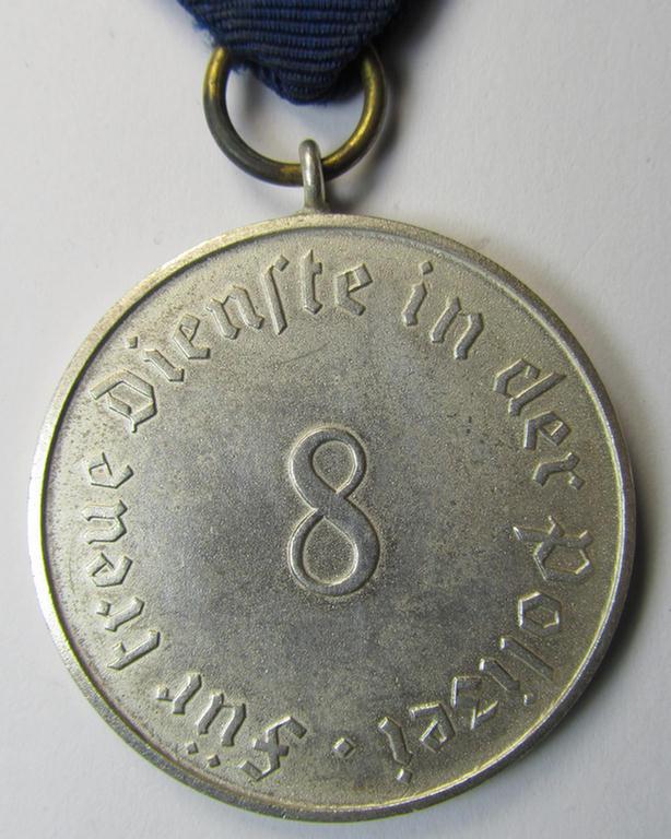 Moderately worn, bright-silver-toned, so-called: 'Polizei-Dienstauszeichnung 3. Stufe' (or: police loyal-service medal third-class) that comes mounted onto its period ribbon (ie. 'Bandabschnitt')