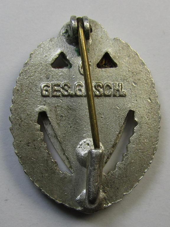 Honorary-membership lapel-pin (aka: 'Silberne Ehrennadel für 25 Jahre Mitgliedschaft im Nationalsocialistischer Reichskriegerbund' (ie. 'N.S.R.K.B.') being a maker- (ie. '6'-) marked example that also bears a: 'Ges.Gesch.'-designation on its back