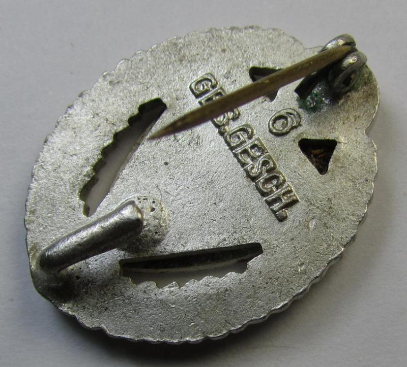 Honorary-membership lapel-pin (aka: 'Silberne Ehrennadel für 25 Jahre Mitgliedschaft im Nationalsocialistischer Reichskriegerbund' (ie. 'N.S.R.K.B.') being a maker- (ie. '6'-) marked example that also bears a: 'Ges.Gesch.'-designation on its back