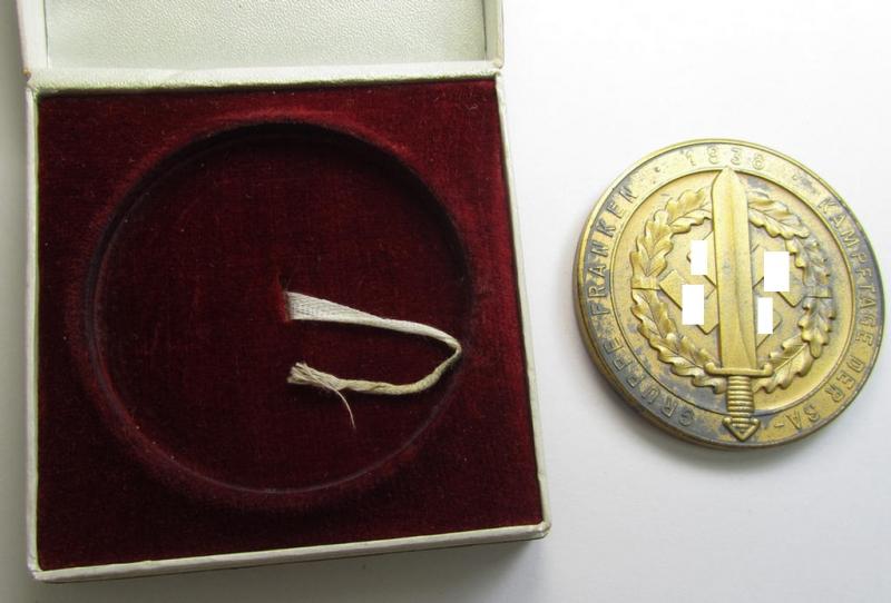 Attractive, golden-toned- (ie. 'Feinzink'-based) so-called: SA- ie. ('Sturmabteilungen'-) related, commemorative-plaque entitled: 'Kampftage der SA - Gruppe Franken - 1938' and showing the text: 'Dem 1. Sieger' and that comes in its period etui