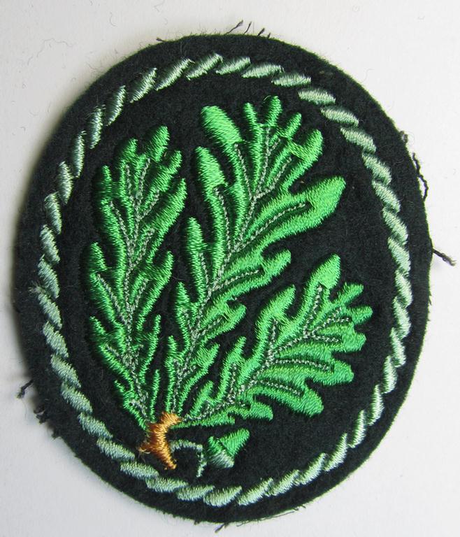 Attractive example of a WH (Heeres) so-called: 'Jäger'-armbadge, being a neatly machine-embroidered- and/or multi-coloured version as was executed on darker-green-coloured wool