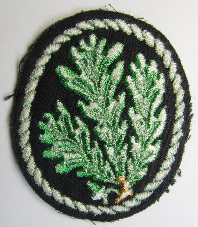 Attractive example of a WH (Heeres) so-called: 'Jäger'-armbadge, being a neatly machine-embroidered- and/or multi-coloured version as was executed on darker-green-coloured wool