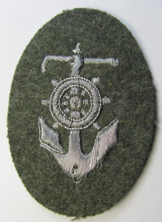 Neat, WH (Heeres) trade- and/or special-career insignia (being a detailed- and/or neatly hand-embroidered example as executed on field-grey-coloured wool as was intended for a: 'Steuermann' ie. enigineer-boat-pilot or helmsman)