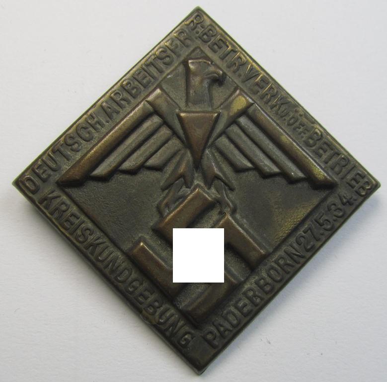 Golden-bronze-toned, (I deem) N.S.D.A.P.-related- (and fairly early-period!) day-badge (ie. 'tinnie') as was issued to commemorate a gathering entitled: 'Kreisführerschule Hans Huebenett - Brieg - 23. Juni 1934'