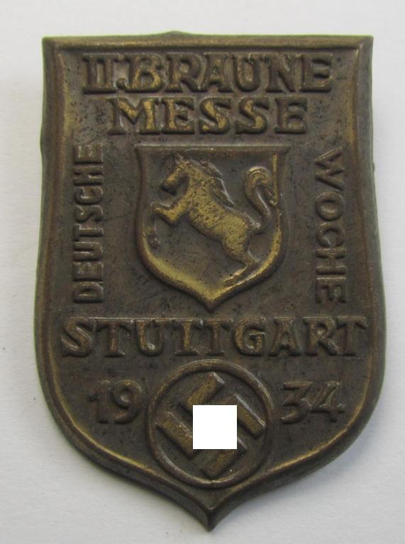 Early-period, golden-bronze-coloured- and/or tin-based, N.S.D.A.P.-related day-badge (ie. 'tinnie' or: 'Veranstaltungsabzeichen') being a commemorative example that is entitled: 'II. Braune Messe -  Deutsche Woche - Stuttgart - 1934'