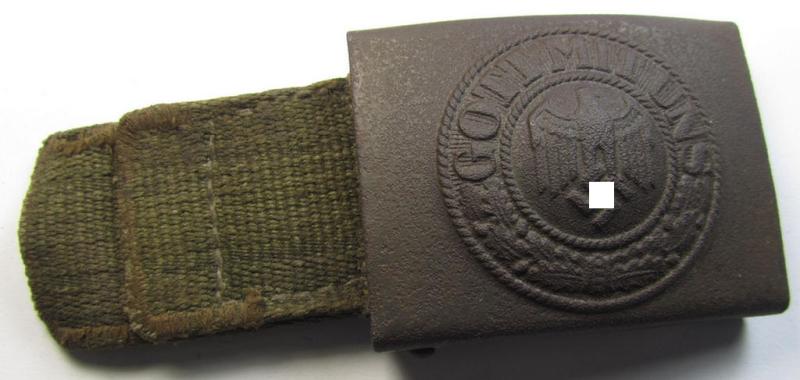 Neat, WH (Heeres) 'tropical-issued' belt-buckle (being a non-maker-marked and/or typical olive-green-coloured) example that comes mounted onto its original, greenish-coloured (and/or: 'webbing'-based-) tab