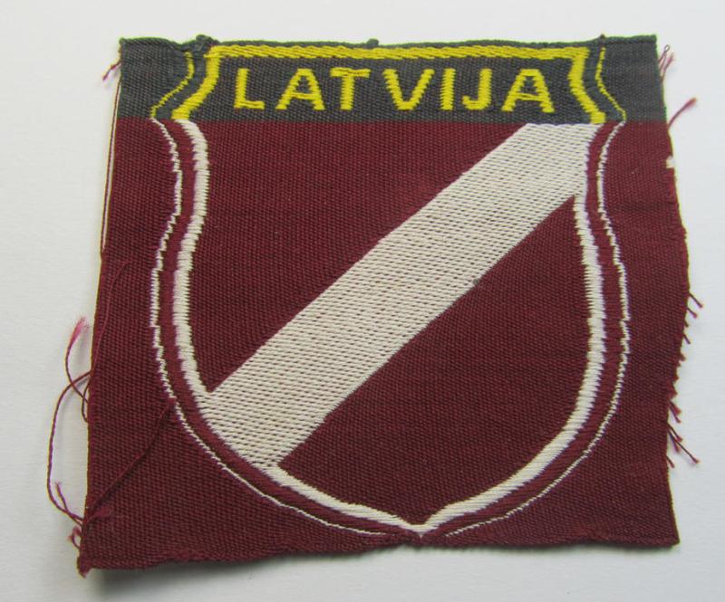 Superb - and truly rarely seen! - locally produced(!), 'Waffen-SS'-type armshield as executed in the so-called: 'semi-BeVo'-pattern entitled: 'Latvia' as was merely intended for usage by the members of the: 'Latvian Legion'