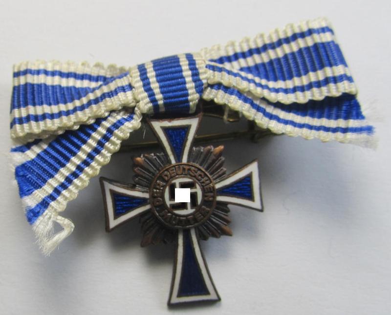 Miniature of an: 'Ehrenkreuz der deutschen Mutter - dritte Stufe' (or: bronze-class mothers'-cross) being a non-maker-marked example that comes in an overall nice- (albeit moderately worn- ie. used-), condition