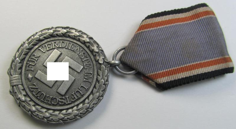 Neat, 'Luftschutz-Ehrenzeichen 2. Stufe' being a non-maker-marked example, as executed in (heavy) zinc-based metal (ie. 'Feinzink') and that comes mounted onto its period ribbon ie. 'Bandabschnitt'