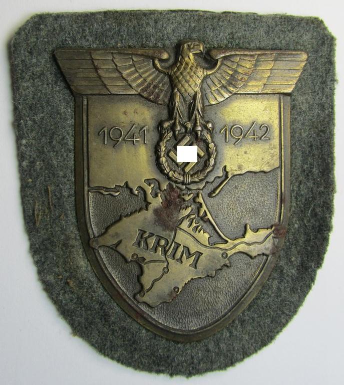 Attractive - albeit minimally rust-stained - WH (Heeres ie. Waffen-SS) 'Krim'-campaign-shield (as was produced by a by me unidentified maker) and that comes in a presumably issued - albeit 'virtually mint', condition