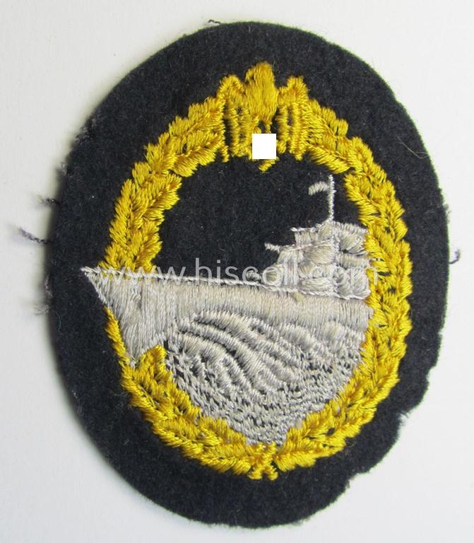 Attractive, WH (Kriegsmarine) 'Zerstörerkriegsabzeichen in Stoff' (ie. cloth-based destroyer war-badge) being a multi-coloured example that that is nicely machine-embroidered on darker-blue-coloured wool