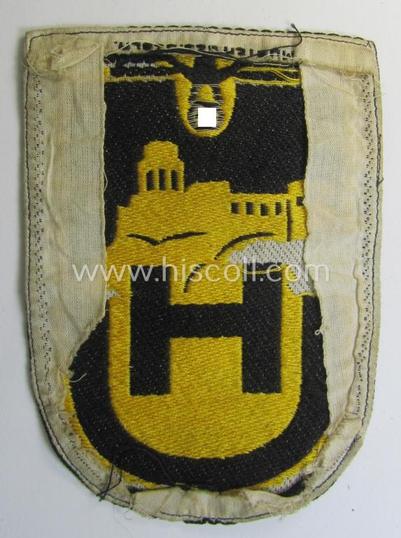 Superb - very unusual and only twice before encountered! - linnen-based- and/or: 'BeVo'-woven (larger!) cloth-based sportshirt-patch depicting a capital: 'H' and 'U'-character as intended for usage by students of the: 'Universität Heidelberg'