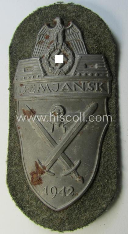 Attractive example of a - fairly scarcely encountered! - WH (Heeres ie. Waffen-SS) 'Demjansk'-campaign-shield as executed in typical magnetic, so-called: 'Eisenblech' (and being of the 'missing-log' variant-pattern)