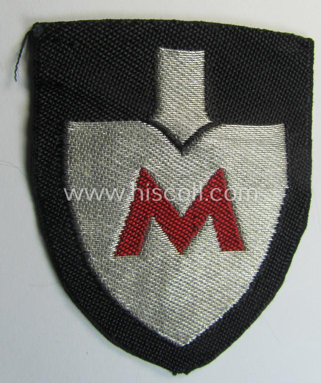 Attractive - and actually scarcely encountered! - officers'-pattern, so-called: RAD (ie. 'Reichsarbeitsdienst') sleeve-badge (or: 'Dienststellenabzeichen') bearing the specialist-designation: 'M' ('Hauptmeldebeambter')