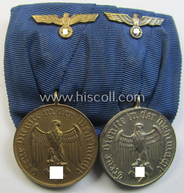 Attractive, two-pieced medal-bar (ie. 'Spange') showing two: WH (Heeres o. Kriegsmarine) so-called: 'Dienstauszeichnungen für 4 u. 12 Jahre Treue Dienste' that both come period-mounted as a so-called: 'Doppelspange'