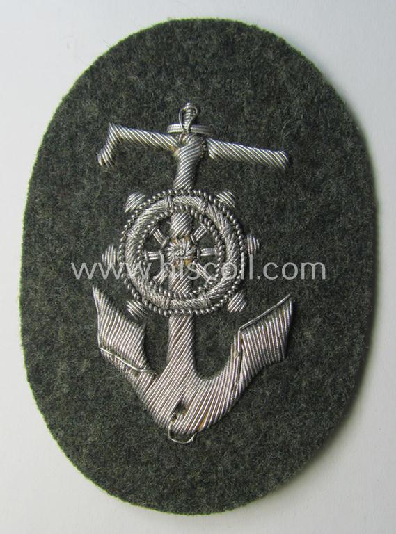 Superb, WH (Heeres) trade- and/or special-career insignia being a detailed- and/or neatly hand-embroidered example as executed on field-grey-coloured wool as was intended for a: 'Steuermann' (ie. enigineer-boat-pilot or helmsman)