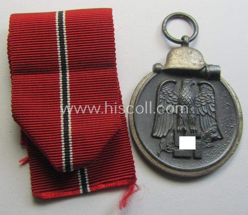 Attractive medal-set: 'Winterschlacht im Osten 1941-42' being a maker- (ie. '14'-) marked- (and/or 'Feinzink'-based) specimen by the maker: 'L.Chr. Lauer' and that comes together with its (minimally confectioned) ribbon (ie. 'Bandabschnitt')