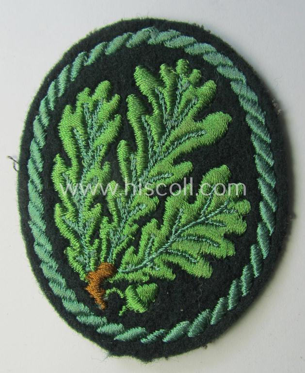 Attractive example of a WH (Heeres) so-called: 'Jäger'-armbadge being a neatly machine-embroidered- and/or multi-coloured version as was executed on darker-green-coloured wool