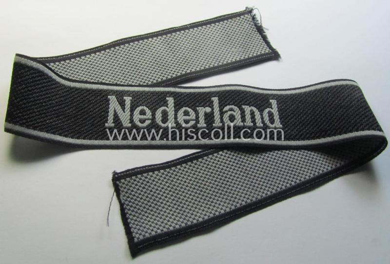 Superb, Waffen-SS, 1943/44 pattern cuff-title (ie. 'Ärmelstreifen') depicting the machine-woven Latin script text in silver-grey linnen as was intended for a member serving within the: '23. SS Freiwilligen Panzer Grenadier Division' ('Nederland')