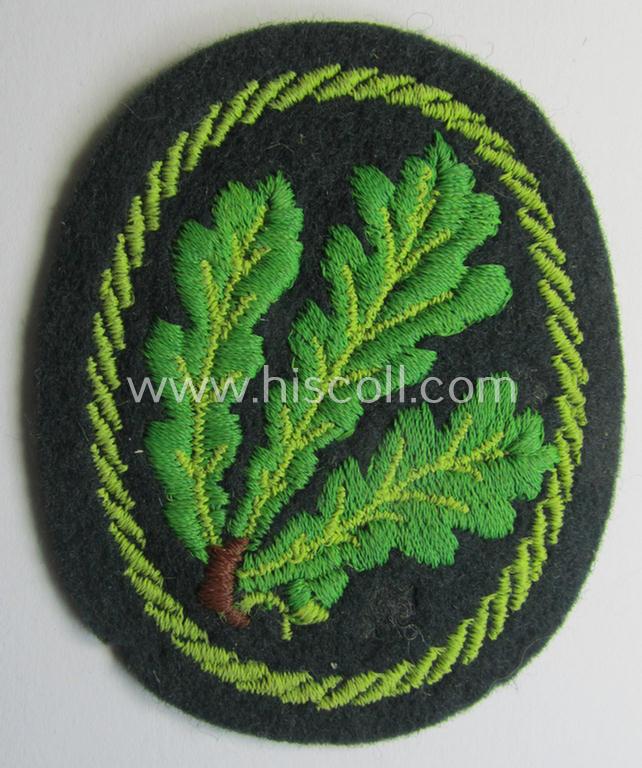Attractive example of a WH (Heeres) so-called: 'Jäger'-armbadge being a neatly machine-embroidered- and/or multi-coloured version as was executed on darker-green-coloured wool