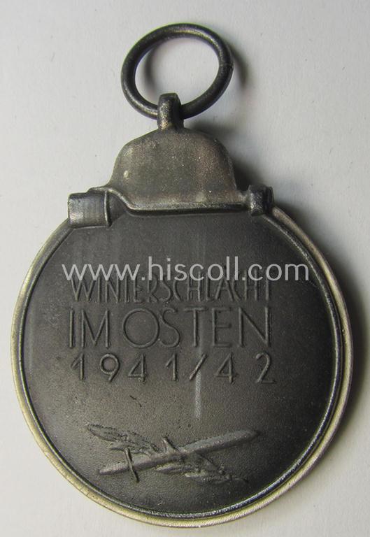 Attractive medal-set: 'Winterschlacht im Osten 1941-42' being a maker- (ie. '127'-) marked- (and/or 'Feinzink'-based) specimen by the maker: 'Moritz Hausch A.G.' and that comes together with its (non-confectioned) ribbon (ie. 'Bandabschnitt')