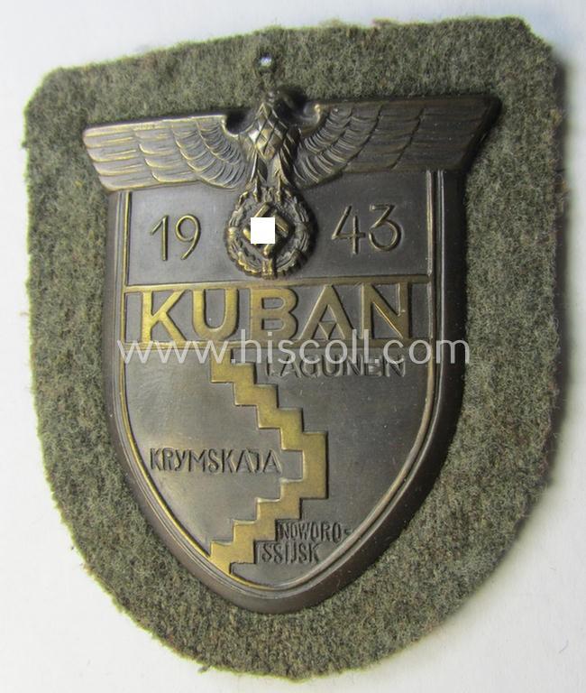Attractive - just minimally used and actually scarcely encountered! - WH (Heeres ie. Waffen-SS) 'Kuban'-campaign-shield that comes mounted onto its original field-grey-coloured- and/or woolen-based 'backing'