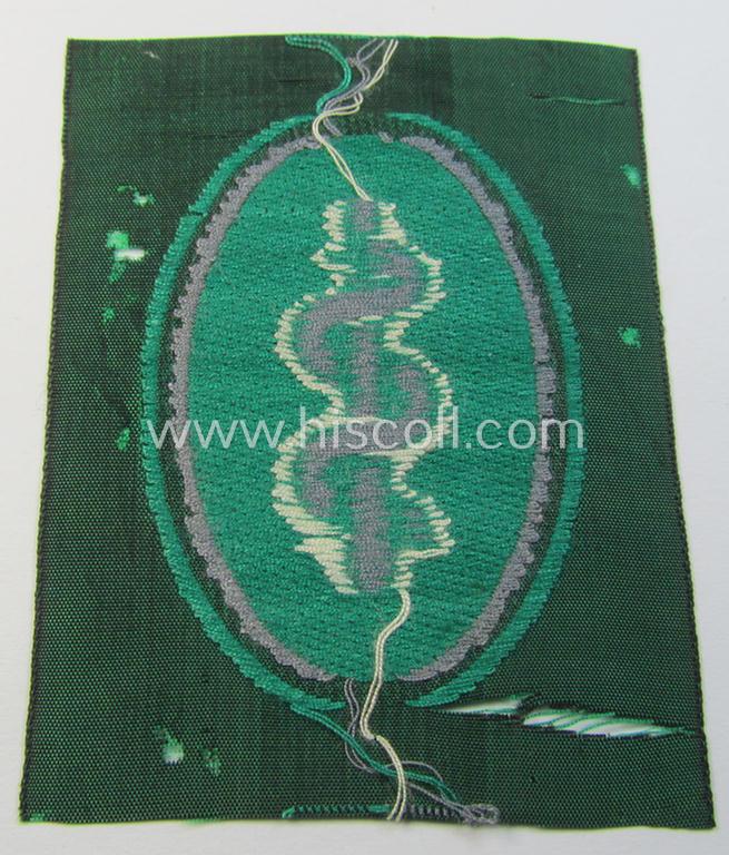 Attractive, 'Sicherheits- u. Hilfsdienst' (ie. 'SHD'-) armbadge (ie. 'Ärmelabzeichen') being a greyish-coloured example depicting an: 'Aesculapus'-symbol as was intended for a: 'Feldscher' (ie. medical SHD-staff-member)