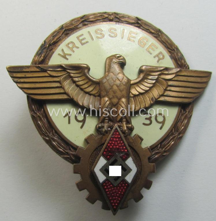 'HJ'- ('Hitlerjugend') ie. 'BDM'- ('Bund Deutscher Mädel') related: 'Reichsberufswettkampf-Siegerabzeichen' (of the 2nd model) entitled: 'Kreissieger 1939' and being a neatly maker- (ie.: 'Ferd. Wagner'-) marked example