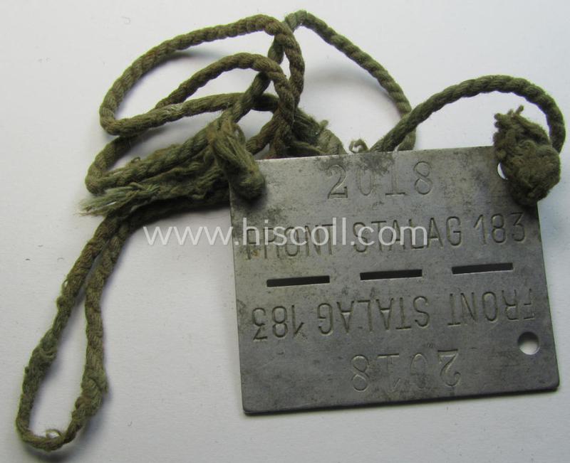Unusually found, zinc-based WH (Heeres) 'Frontstalag'- (ie. prisoner-related-) ID-disc bearing the clearly stamped camp-designation that reads: 'Frontstalag 183' and that comes still mounted onto its (period-attached) cord as issued- and/or worn