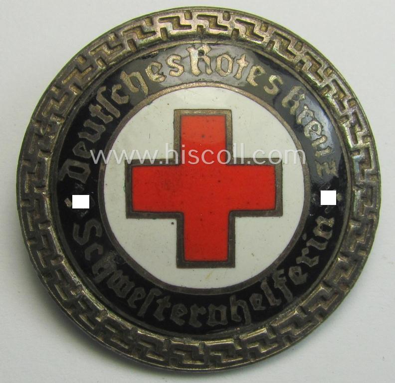 DRK (ie. 'Deutsches Rotes Kreuz' or German Red Cross) nurses'-helpers-badge entitled: 'Schwesternhelferin' (being an example that shows a: 'Ges.Gesch.'-patent-pending (and '1'-) marking on its back