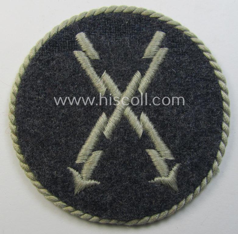 Attractive - and hardly used! - example of a WH (Luftwaffe) machine-embroidered, trade- ie. special-career-patch (ie. 'Tätigkeitsabzeichen') having a silverish-grey-toned 'Kordel' attached as was intended for: 'LW-Fernschreib-Unteroffiziere'