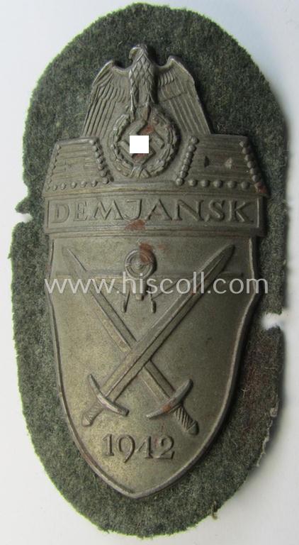 WH (Heeres ie. Waffen-SS) 'Demjansk'-campaign-shield as executed in typical magnetic metal (ie. so-called: 'Eisenblech') and that comes in an overall very nice- ie. fully untouched, condition