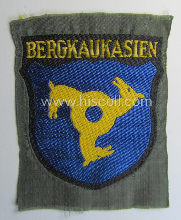 Attractive, 'BeVo'-type armshield (of the second pattern-) entitled: 'Bergkaukasien', being a piece as intended for a volunteer who served within the 'Deutsche Wehrmacht' ie. within the 'Berg- o. Nord-Kaukasisches Legion'