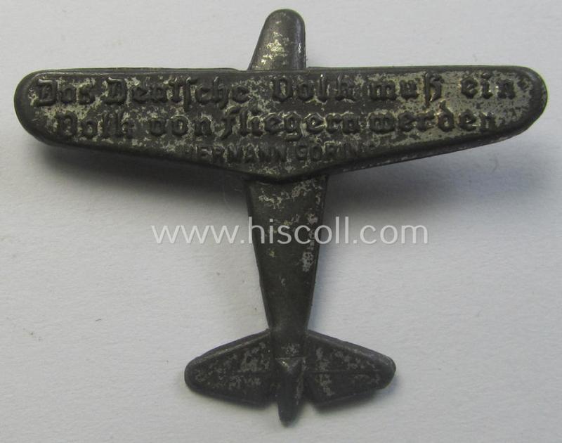 Commemorative, greyish-toned so-called: 'Flieger'- (ie. 'WHW'-) related day-badge (ie. 'tinnie') being a non-maker-marked example showing the text: 'Das Deutsche Volk muss ein Volk von Fliegern werden - Herrmann Göring'
