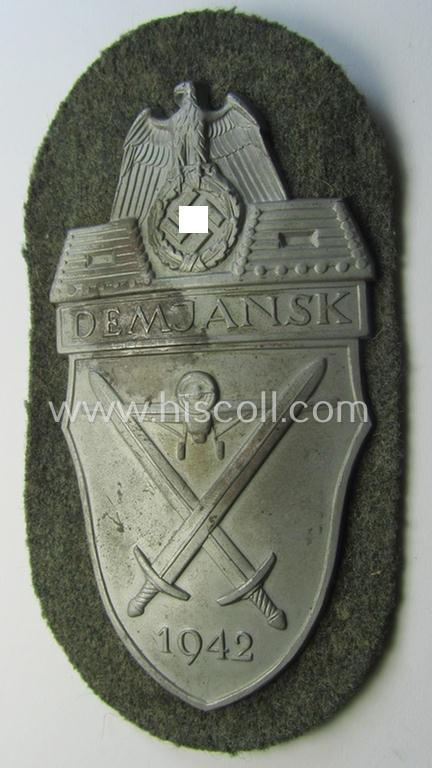 WH (Heeres ie. Waffen-SS) 'Demjansk'-campaign-shield as executed in typical magnetic metal (ie. so-called: 'Eisenblech') and that comes in an overall very nice- ie. fully untouched, condition
