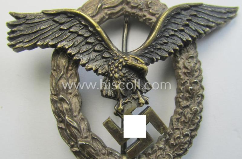 Early- (ie. pre-) war-period- and/or: 'Buntmetall'- (ie. 'Tombak'-) based: WH (Luftwaffe) 'Flugzeugführerabzeichen' (or: pilots-badge) being a clearly maker- (ie. 'C.E. Juncker'-) marked example of the 'J2'-pattern