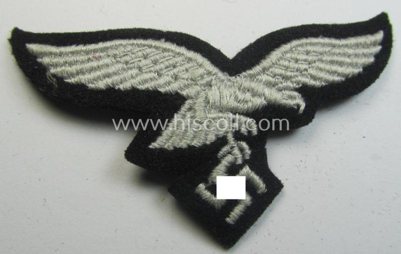 Attractive, WH (Luftwaffe) cap-eagle (being a 'standard-issue'-pattern example as executed onto a black-coloured and woolen-based background and as such intended for usage on the black-coloured work- ie. 'HG'-related side-caps ie. 'Schiffchen')