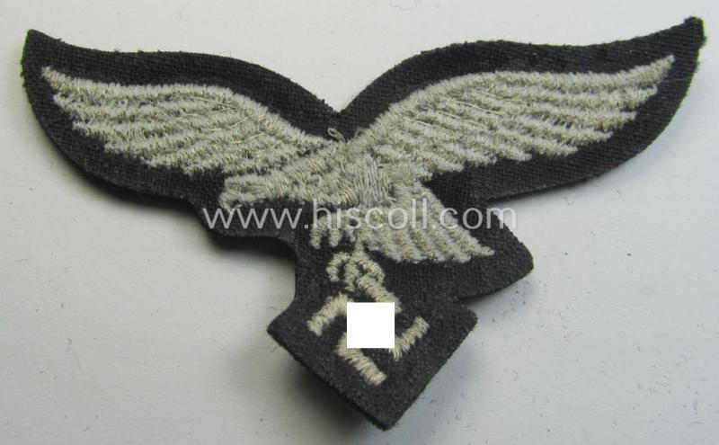 Attractive, WH (Luftwaffe) cap-eagle (being a 'standard-issue'-pattern example as executed onto a black-coloured and woolen-based background and as such intended for usage on the black-coloured work- ie. 'HG'-related side-caps ie. 'Schiffchen')