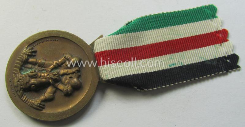 Attractive, golden-bronze-coloured- (and I deem 'Buntmetall'-based-) example of a: 'Deutsch-Italienische Feldzugsmedaille' (or: German-Italian campaign-medal) that comes mounted onto its (Italian-styled) piece of original (and non-faded!) ribbon