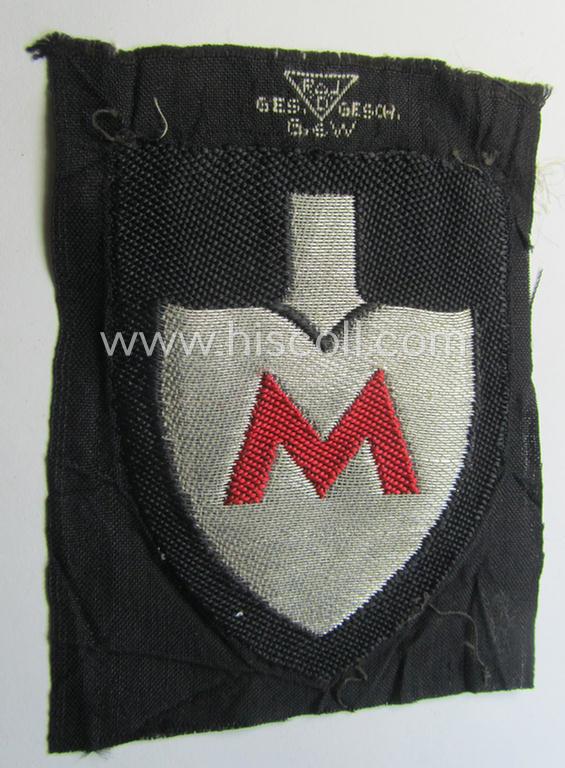 Attractive - and actually very scarcely encountered! - officers'-pattern, so-called: RAD (ie. 'Reichsarbeitsdienst') sleeve-badge (or: 'Dienststellenabzeichen') bearing the specialist-designation: 'M' (or: 'Hauptmeldebeambter')