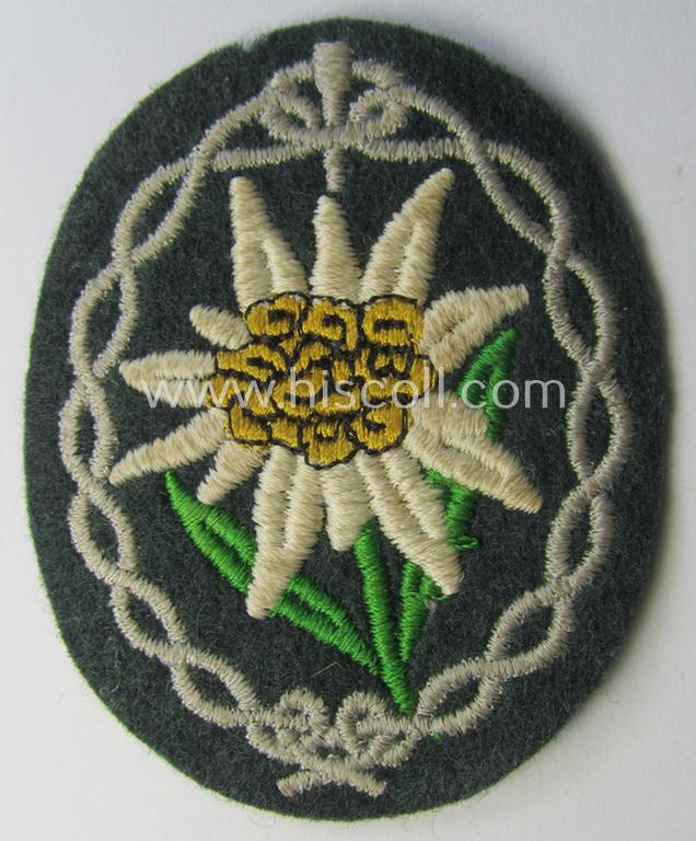 Minimally used and/or tunic-removed, WH (Heeres) EM- (ie. NCO-) type, so-called: 'Edelweiss'-armpatch being a machine-embroidered example as was executed on darker-green wool as was specifically intended for usage by the: 'Gebirgsjäger-Truppen'
