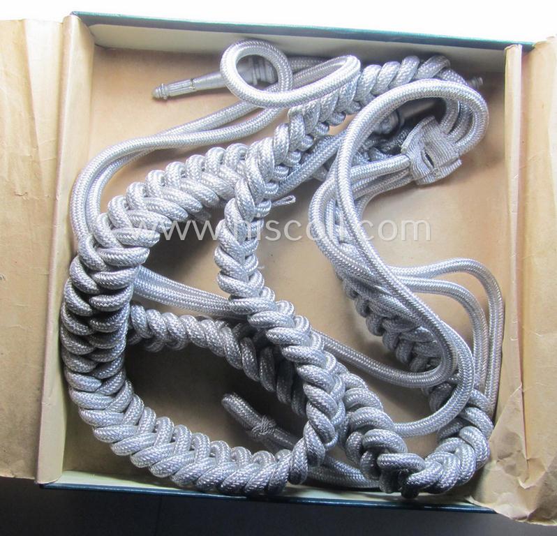 Bright-silver-toned, WH (Heeres): 'Paradefangschnur für Adjutanten' (ie. adjutants'-aiguillette) that comes stored in its period, carton box as issued
