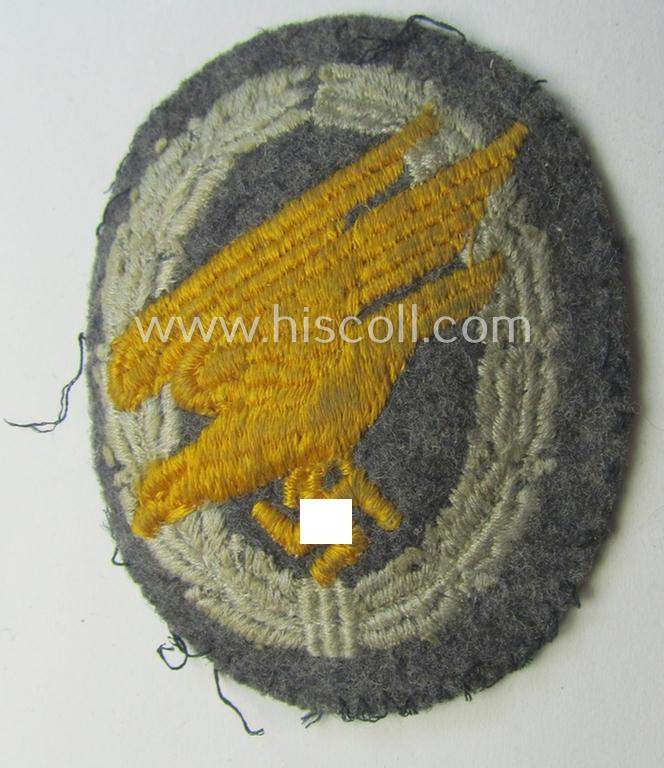 WH (Luftwaffe) 'Fallschirmschützen-Abzeichen in Stoff' (or: cloth-based paratroopers' jump-badge) that is nicely machine-embroidered and being of the so-called: 'padded version'