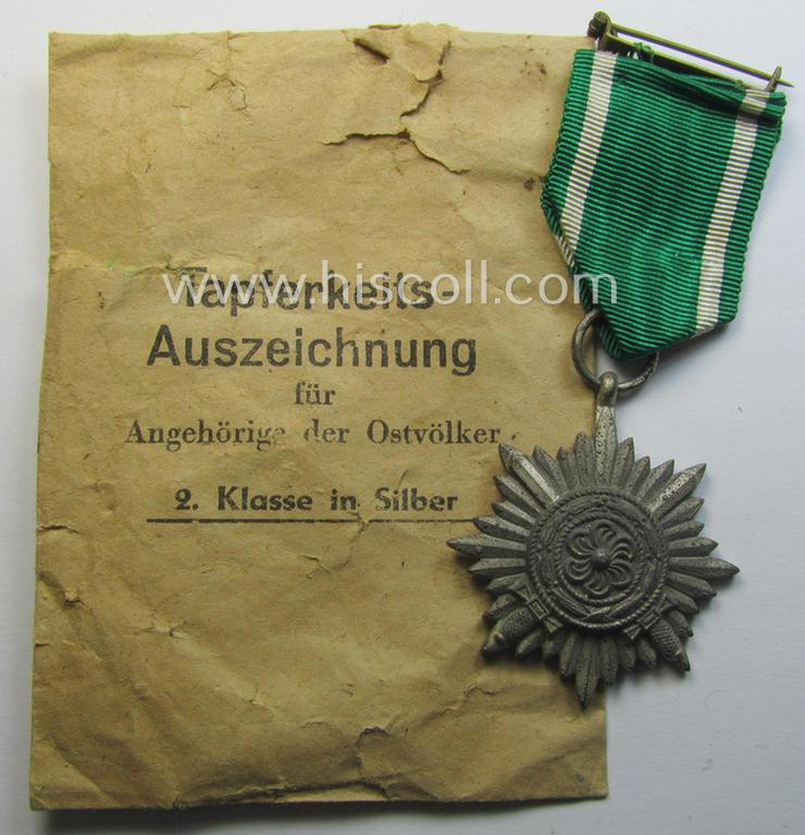 WH-related 'Tapferkeitsauszeichnung für Angehörige der Ostvölker, 2. Kl. in Silber mit Schwn.' (being a 'Feinzink'-based example that comes stored in its period pouch)