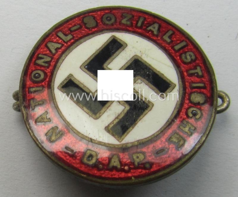 Smaller-sized- and early-period, bright-red-coloured 'N.S.D.A.P.'-membership-pin- ie. party-badge (or: 'Parteiabzeichen') which is maker-marked on its back with a (by me) unidentified makers'-designation (ie. logo)