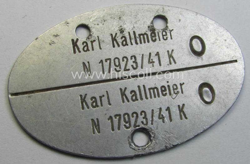 Early-war- (albeit 'standard-issue'-) pattern, WH (Kriegsmarine) typical aluminium- based- and silver-toned ID-disc (ie. 'Erkennungsmarke') bearing the engraved numeral (ie. date) that reads: 'Karl Kallmeier N 17923/41 K'